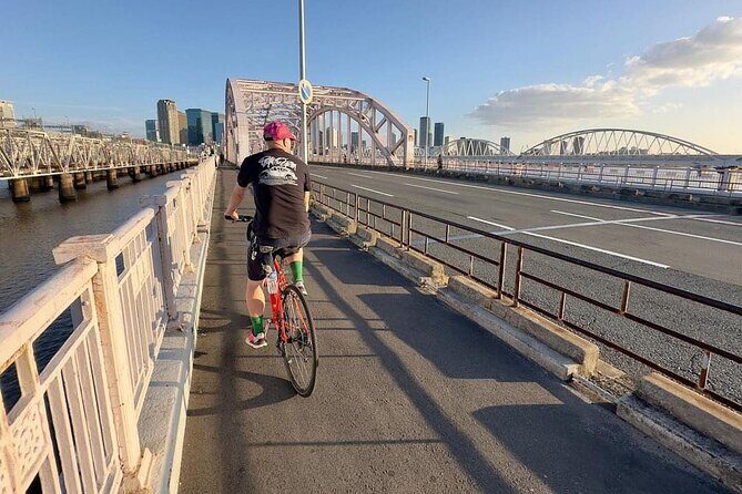 Urban Canvas: Osaka Street Art Bike Tour - Stop 1: Osaka’s urban maze—train lines, rivers, bridges, and skyline